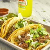 Ground Beef Taco · Double corn tortilla, ground beef, onion and cilantro.