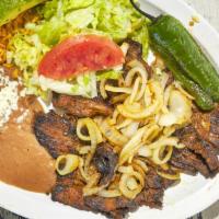 Carne Asada · Juicy steak topped with caramelized onions and one fried jalapeno served with rice and beans...