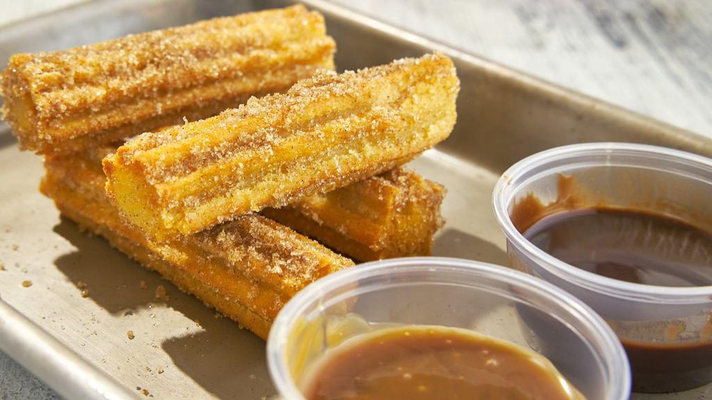 Churros · Fried-dough pastry with cinnamon and sugar. Served with hot chocolate and caramel.