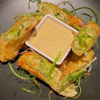 Chicken & Avocado Egg Rolls · Hand rolled in house, stuffed with avocado, oven roasted pulled chicken and guacamole, flash...