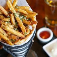 Truffle Parmesan Fries^ · Crispy fries, tossed in white truffle oil, Parmesan cheese, and house seasoning with rosemar...