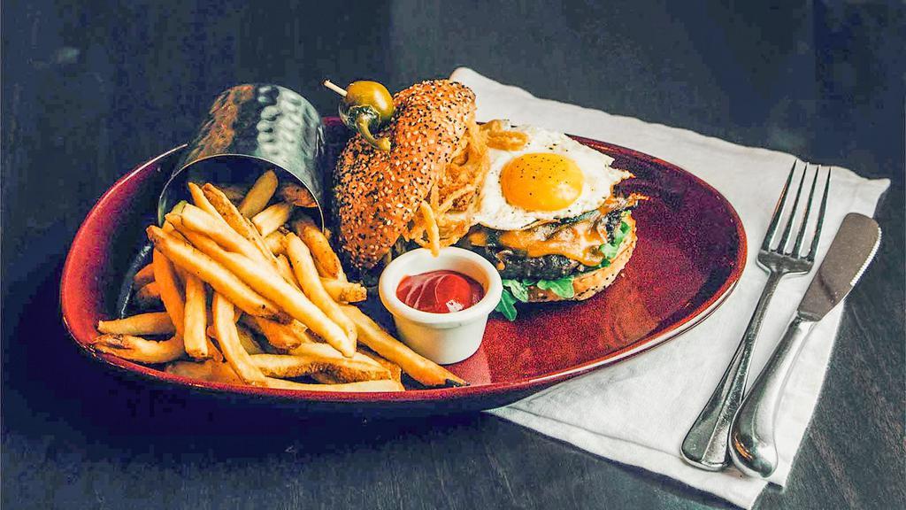 Bison Burger · House-made bison patty, caramelized onion, mushroom conserva, naturally
smoked cheddar, Crave burger sauce, fried onions and sunny side up egg, all piled on an everything bun.
