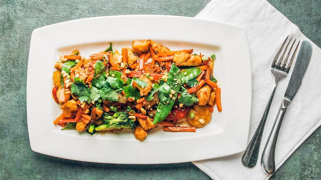 Chicken Stir Fry · Fresh cut chicken breast seared and tossed with fresh vegetable medley then glazed with soy chili sauce served over coconut jasmine rice finished with cilantro and chopped peanuts.