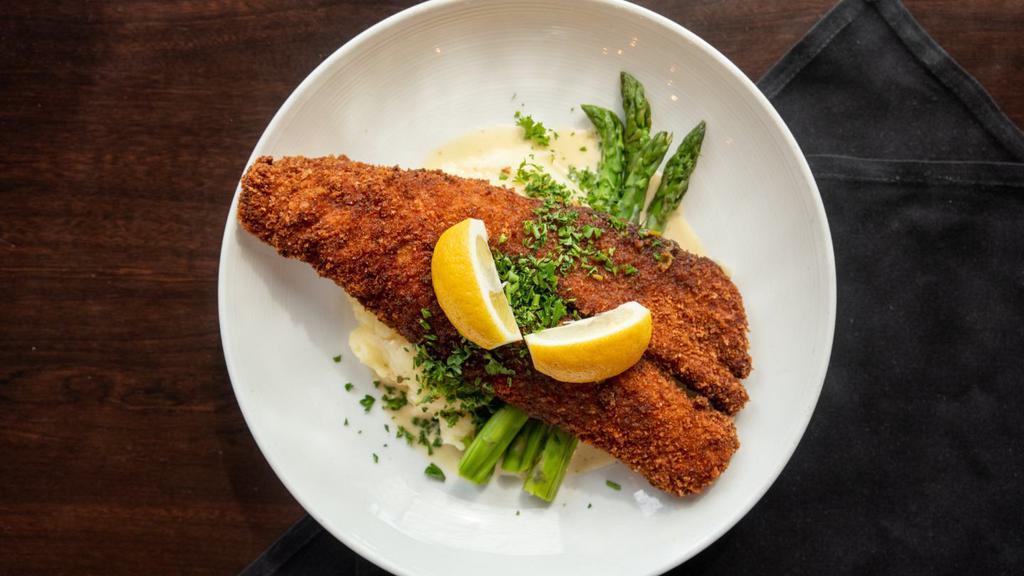 Shore Lunch Walleye · wild Canadian walleye fillet breaded with parmesan & panko bread crumbs, fried to perfection, topped with lemon cream sauce & served with grilled asparagus & buttermilk mashed potatoes.