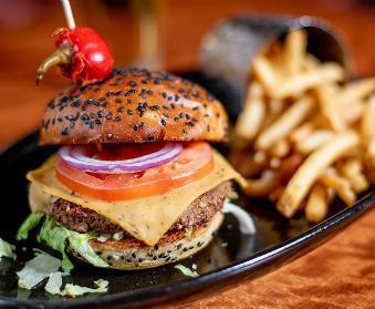 Crave Veggie Burger · Impossible burger, topped with smoked cheddar, iceberg lettuce, beefsteak tomato, and crave signature house-made burger sauce.