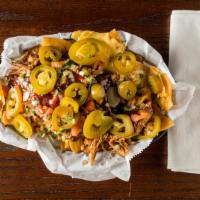 Bbq Nachos · Crispy tortilla chips layered with smoked pulled pork or pulled chicken, cheese, pico de gal...