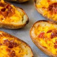 Potato Skins · With bacon, cheddar cheese, and sour cream.