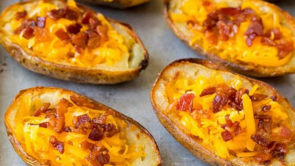 Potato Skins · With bacon, cheddar cheese and sour cream.