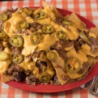 Southern Nacho Platter · Freshly fried nacho chips topped with choice of meat, homemade chili, cheddar cheese sauce, ...