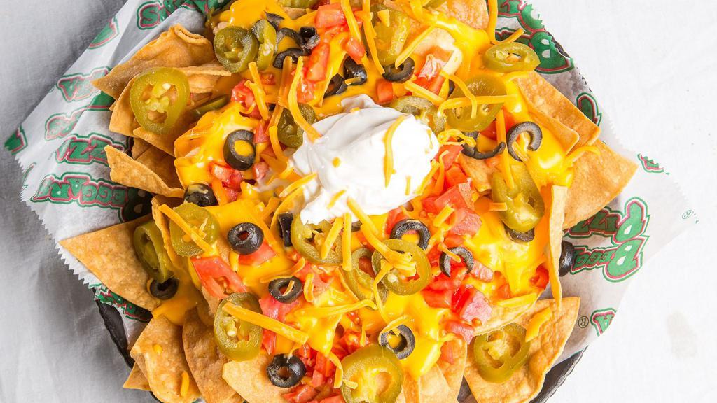 Classic · Tortilla chips topped with cheddar cheese, cheese sauce, sour cream, black olives, tomatoes and jalapenos. 1372 cal.
