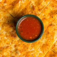 Beggars Cheesy Flatbread · Pizza crust brushed with garlic butter and seasoning, then baked with Mozzarella, Cheddar an...