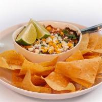 Elote Queso · Elote-style queso dip with roasted corn, cotija, cilantro, queso fresco and lime. Served wit...