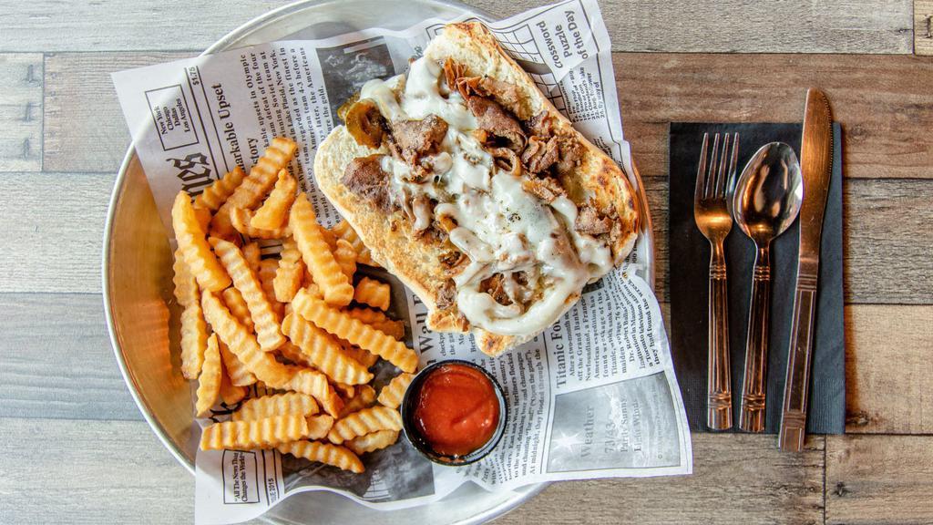 Philly Cheese Steak Sandwich · Steak, green peppers, onions and provolone cheese served with a side of fries.