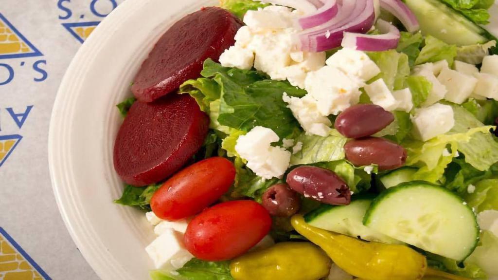 Greek Salad · Lettuce, cherry tomatoes, red onions, kalamata olives, cucumbers, green peppers, beets, pepperoncinis, feta cheese, Greek dressing.
