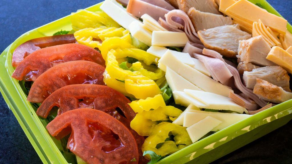 Chef Salad · Lettuce, ham, turkey, Swiss American cheese and American cheese, tomato, mild pepper rings with your choice of dressing.