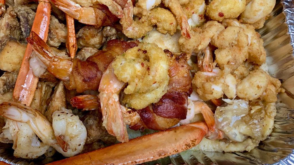 Mariscos · Platter includes shrimp sautéed in garlic sauce, spicy red chili sauce, bacon wrapped shrimp, grilled & breaded shrimp, fried octopus, 1 whole tilapia, fried & grilled tilapia, & crab legs.
