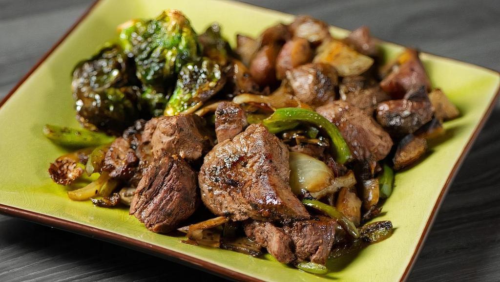Tenderloin Beef Tips · Seasoned, grilled beef tips topped with sauteed onion, green pepper and mushrooms, served with roasted red skins and roasted brussels sprouts.