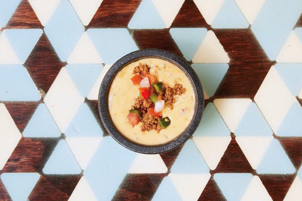 Smoked Cheddar Queso · smokey cheddar queso, topped with pico de gallo and ground beef