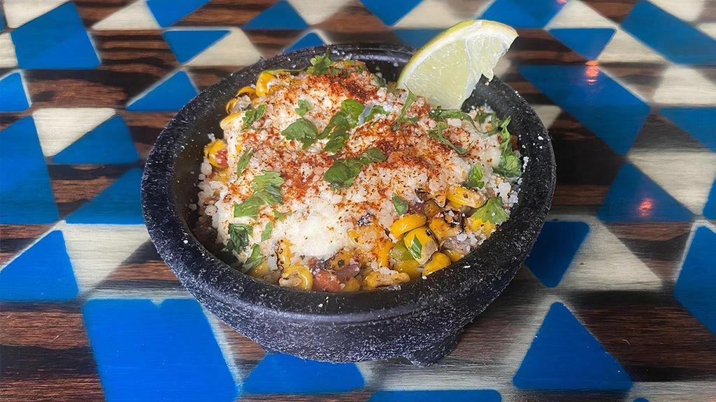 Side Mexican Street Corn · Limited Time Mexican Street Corn is a fire roasted corn off the cob, with sauteed diced jalapeno, red onion, red peppers ,and garlic. Then topped with cilantro lime aioli, cotija cheese, tajin and cilantro.