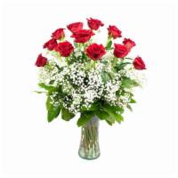 Classic Dozen Deluxe · A dozen long stemmed roses arranged in a vase accented with delicate baby's breath.