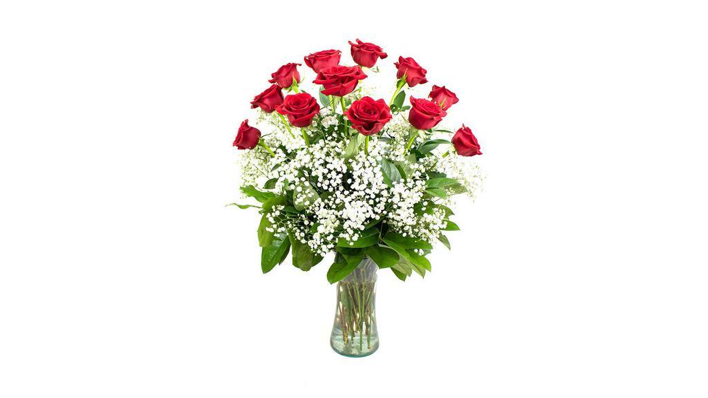 Classic Dozen Deluxe · A dozen long stemmed roses arranged in a vase accented with delicate baby's breath.