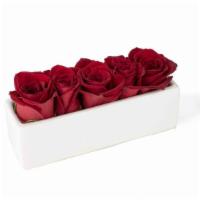 Get In Line · A classy, contemporary arrangement of red roses in a matte white ceramic vase.