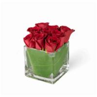 Squared Away · Classic red roses are tucked in a modern glass cube vase lined with aspidistra.