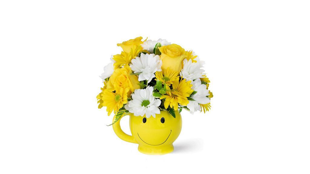 Sunshine Deluxe · C’mon get happy! White and yellow daisy poms and yellow roses arranged in a sweet smiley-face mug.