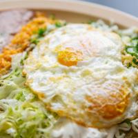 Huevos Rancheros · 2 over easy Eggs coated with Mole and served with Rice and Beans.