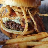 Black & Blue Burger · Blue cheese crumbles and Canadian bacon top this burger seasoned with Cajun spices, topped w...