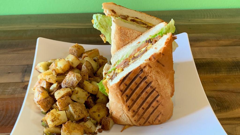 Breakfast Sandwich · Served on toasted french bread with two scrambled eggs mayo, lettuce, tomatoes and a side of house potatoes.