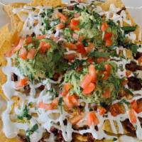 Nachos W/ Meat · Tortilla chip Beans chihuahua cheese sour cream and guacamole and your choice of meat.