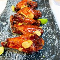Korean Chili Wings · A staff favorite! This amazing sauce starts sweet and ends with heat. Tangy Pluck’d BBQ Sauc...