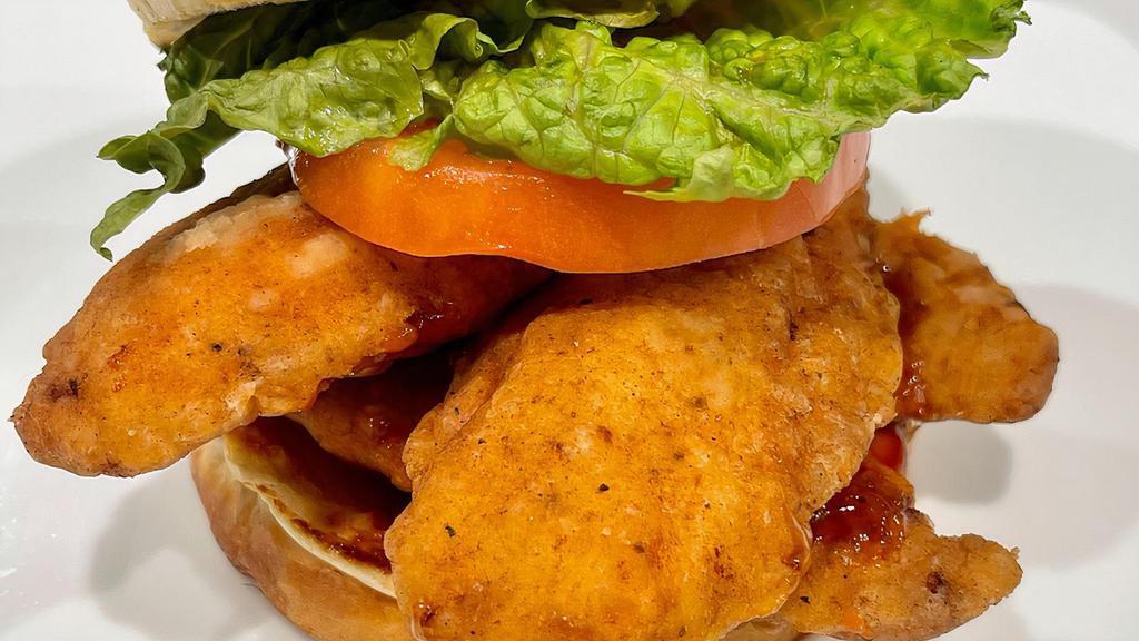Fried Chicken Tender Sandwich · Double breaded and fried Chicken Tenders, Lettuce, Tomato, Brioche. Choice of Sauce. Served with side of Seasoned Fries.
