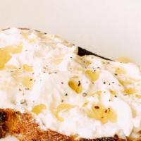Burrata Toast · Burrata is an Italian cow milk made from mozzarella and cream.  We serve it with toasted bre...