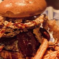 Bourbon Burger · Topped with bacon, onion straws, smoked gouda and dripping with maker's mark sriracha bourbo...