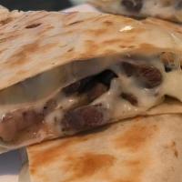Steak Quesadilla · Steak and shredded melted cheese in a crispy flour tortilla and served with a side of pico d...