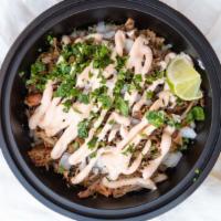 Classic Carnitas Bowl · Slow-roasted pork shoulder, rice*, pinto beans, cheese, spicy sour cream, onion, cilantro, a...