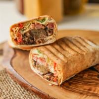 Shawarmbaa · Juicy lamb stuffed in a pita wrap with lettuce, onions and peppers dressed with minty tzatziki