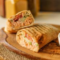Swimming Shawarma · Marinated salmon with herbs and spices grilled to perfection served in a pita with lettuce, ...