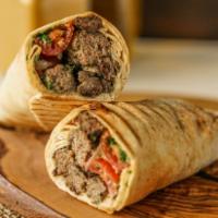 Grilled Grazer · Grilled spiced beef meatballs, wrapped in pita with  tomato-onion relish and hummus