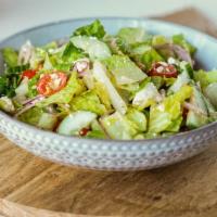 Mediterranean Salad · Romaine lettuce with garbanzo beans, cucumbers, cherry tomatoes, onions and za’atar, topped ...