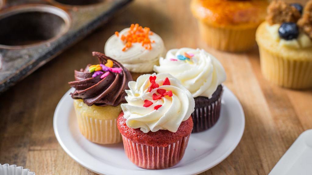 1 Dozen Assorted Minis · Chef's Choice! An assortment of our classic mini flavors, which may include vanilla, chocolate, red velvet and carrot, topped with an assortment of our most popular frostings and sprinkles. Suggested serving is 2-3 per person.