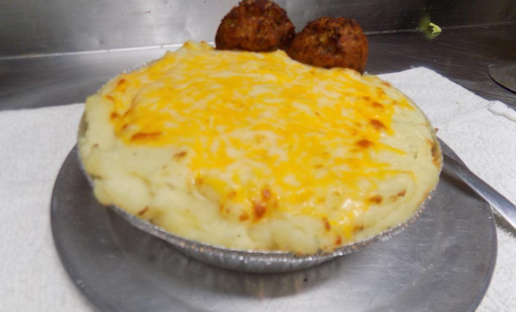 Shepards Pie · Huge portion of lightly goldened mash potato's served over a bed of Hamburger meat, tossed with our special ingredients. Topped with cheese! Served with 2 Irish Boxty's!