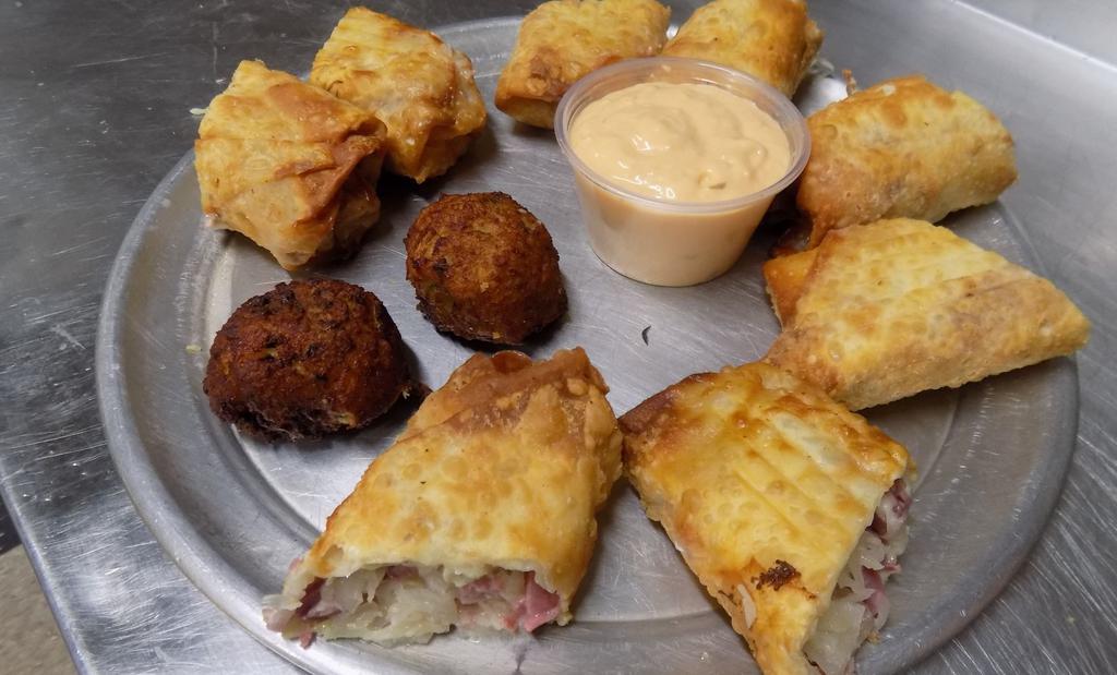Fried Rueben Wrap · Four big wraps. Filled with corned beef, swiss cheese, sauerkraut, wrapped up and fried, thousand island dipping sauce. Served with 2 Irish Boxty's!