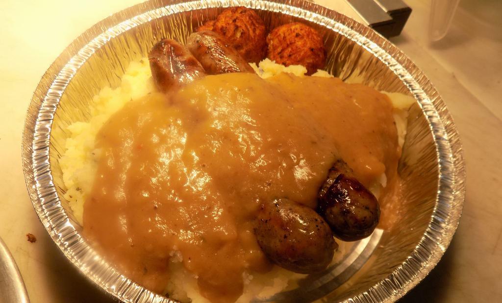 Bangers And Mash · Huge portion of  mash potato's, with 2 Large  Irish Bangers on top. Smothered in Guinness Gravy! Served with 2 Irish Boxty's!