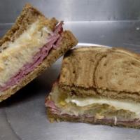 Reuban · Sliced rye Bread with a large portion of Corned Beef, Sauerkraut, Swiss Cheese and Thousand ...