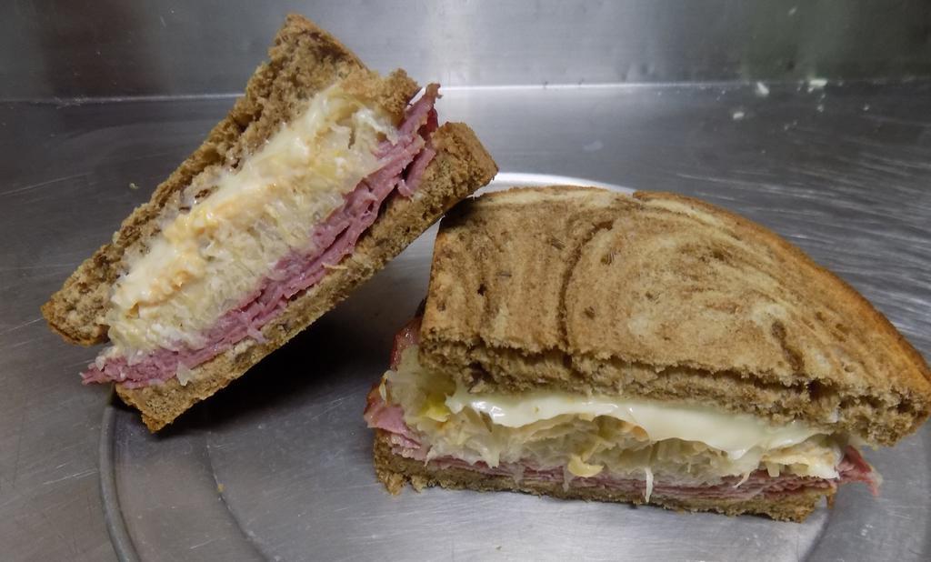 Reuban · Sliced rye Bread with a large portion of Corned Beef, Sauerkraut, Swiss Cheese and Thousand Island. Toasted! Served with 2 Irish Boxty's!