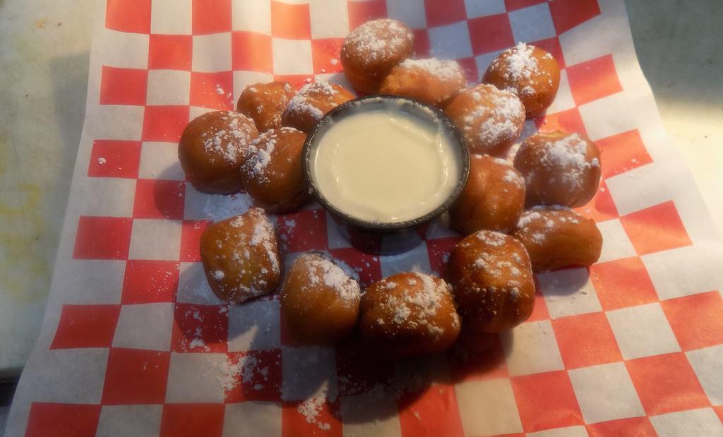 12 Doughnut Holes · A Dozen fried with cinnamon Toast Crunch Dust, or Powdered Sugar. Served with our home made dipping sauce.