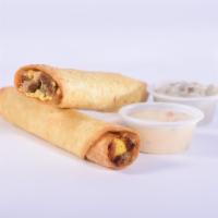 Breakfast Taquitos Combo Meal · Includes two. Scrambled eggs, diced sausage, diced ham, crumbled bacon, spicy cheese sauce a...